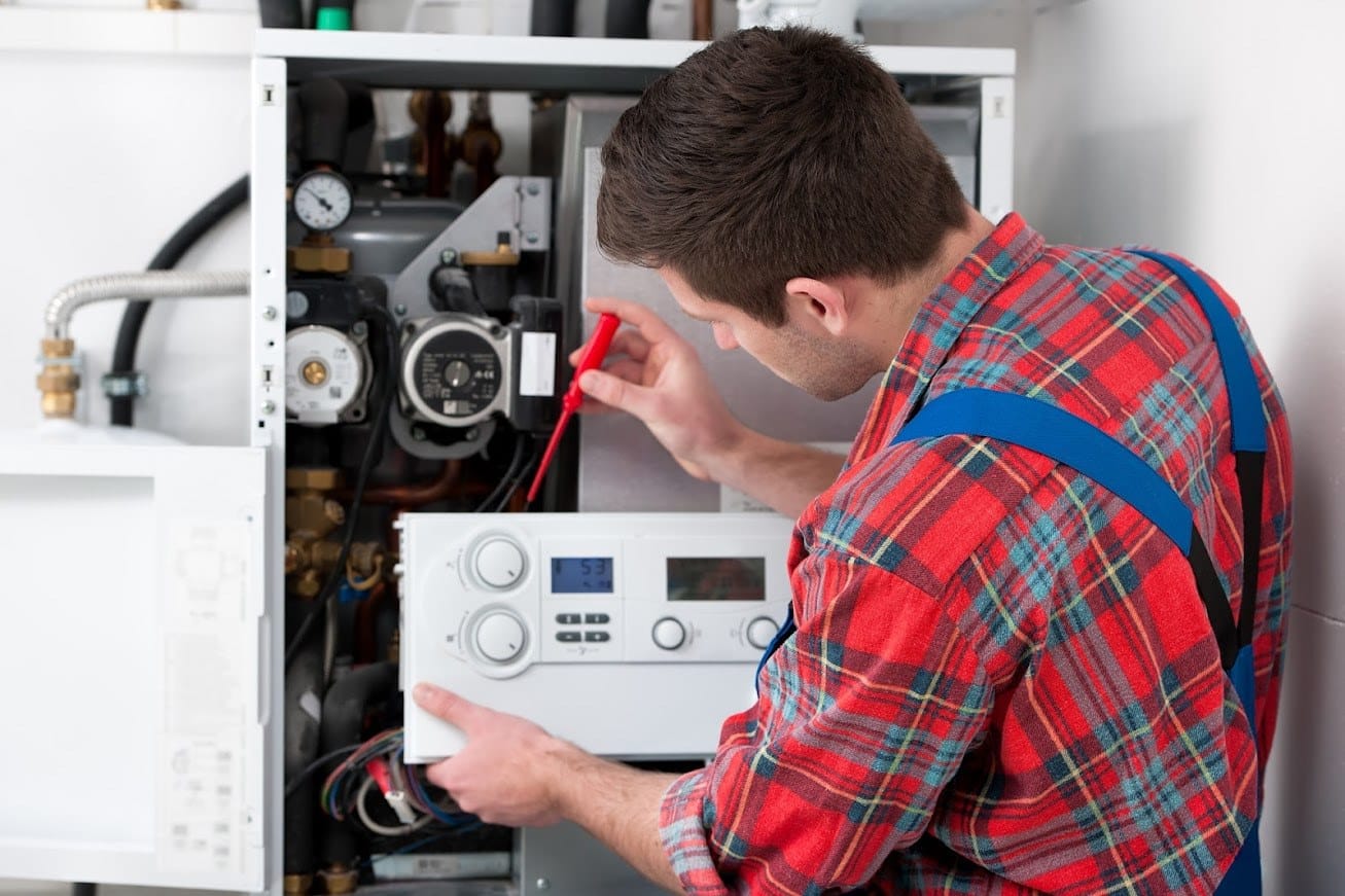 Furnace Technician Working On Controls 1